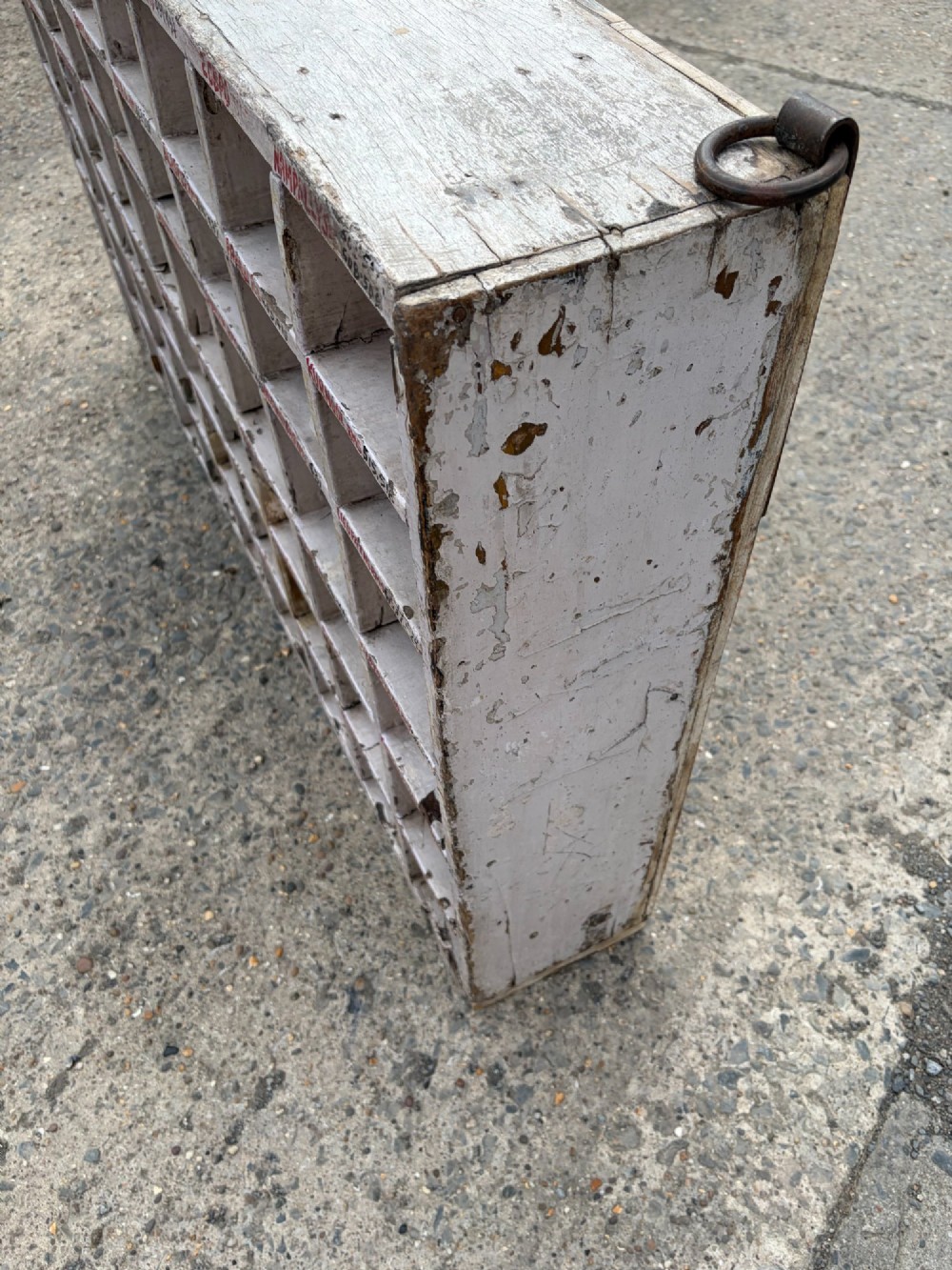 An early twentieth-century painted pine pigeon hole storage unit with a rectangular grid layout and red painted slot labels. View III