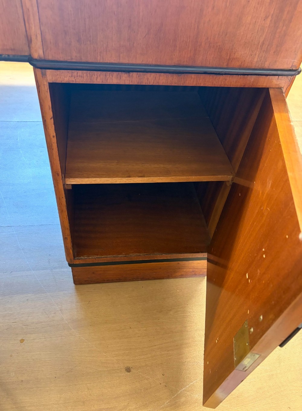A large Art Deco walnut partner desk featuring a brown leather inset top and black horizontal drawer handles. View II
