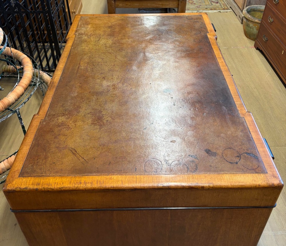 A large Art Deco walnut partner desk featuring a brown leather inset top and black horizontal drawer handles. View III