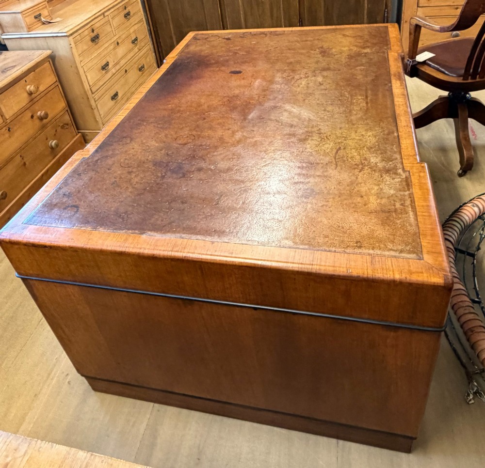 A large Art Deco walnut partner desk featuring a brown leather inset top and black horizontal drawer handles. View XII