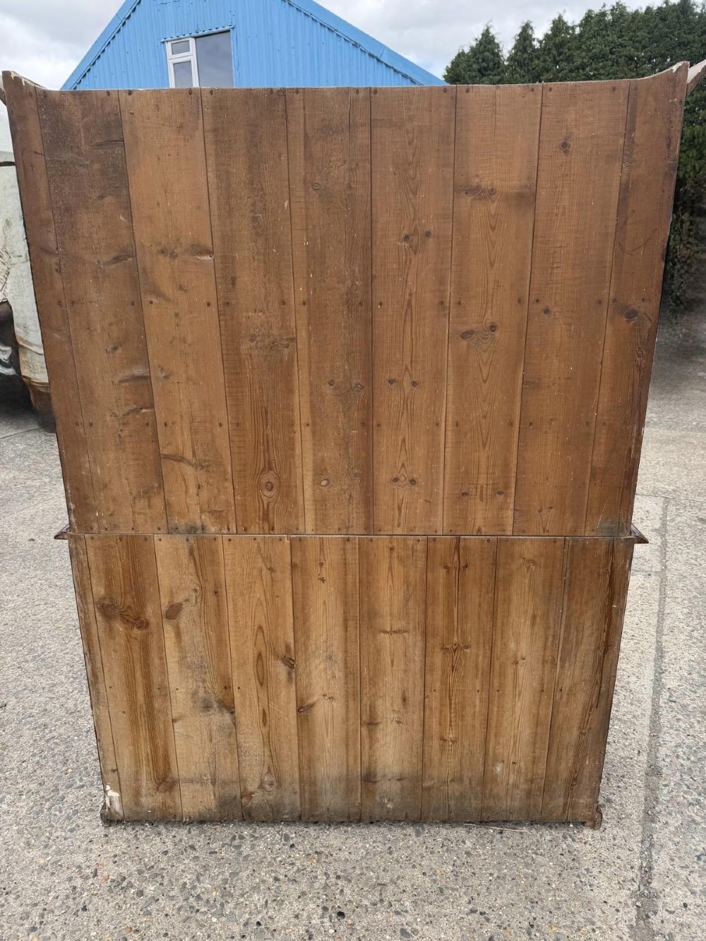 A dark stained Victorian pine dresser featuring a three-door glazed upper display cabinet over a base with three central drawers and two panelled cupboard doors. View II