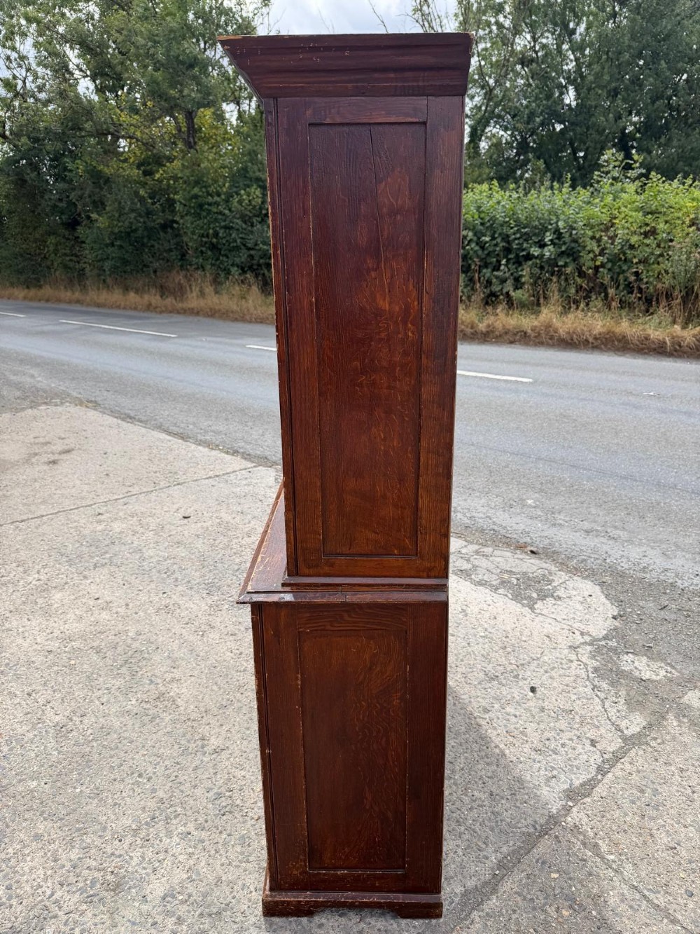 A dark stained Victorian pine dresser featuring a three-door glazed upper display cabinet over a base with three central drawers and two panelled cupboard doors. View VIII