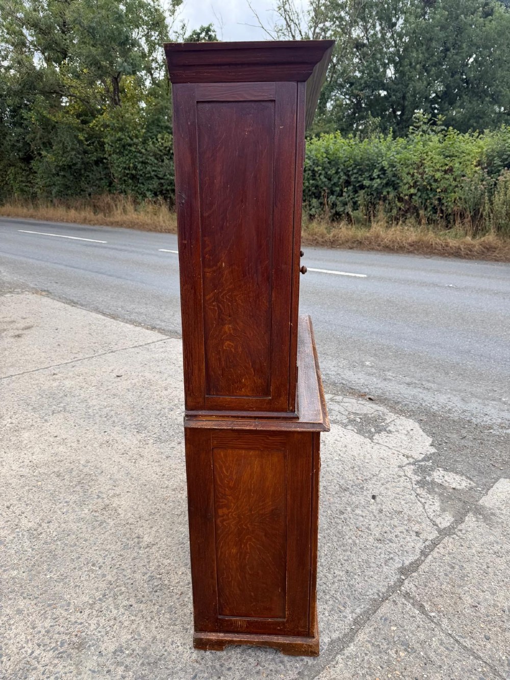 A dark stained Victorian pine dresser featuring a three-door glazed upper display cabinet over a base with three central drawers and two panelled cupboard doors. View XI