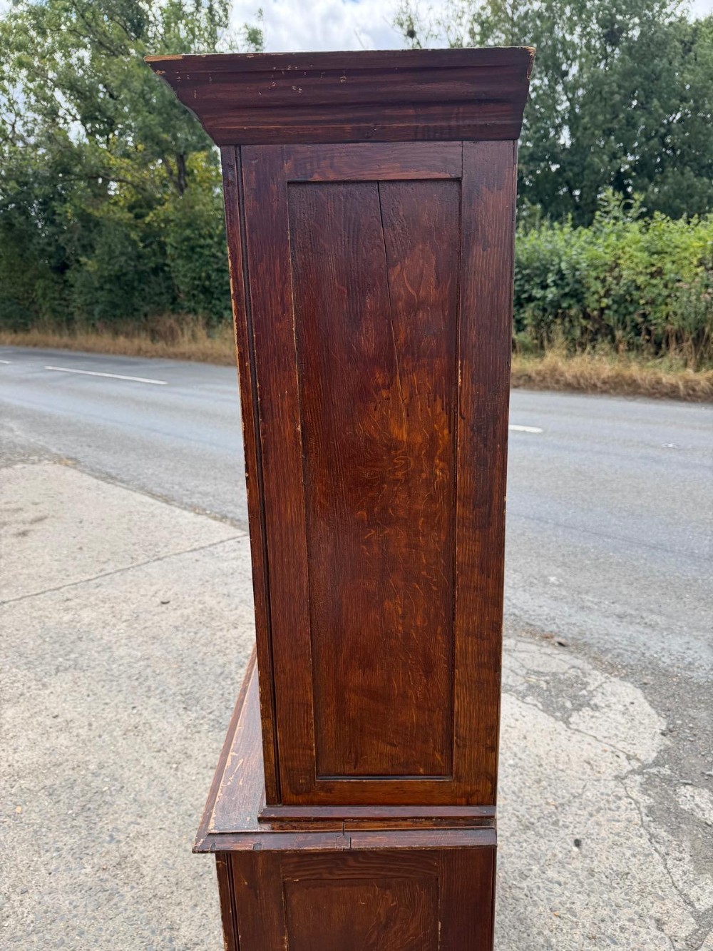 A dark stained Victorian pine dresser featuring a three-door glazed upper display cabinet over a base with three central drawers and two panelled cupboard doors. View XII