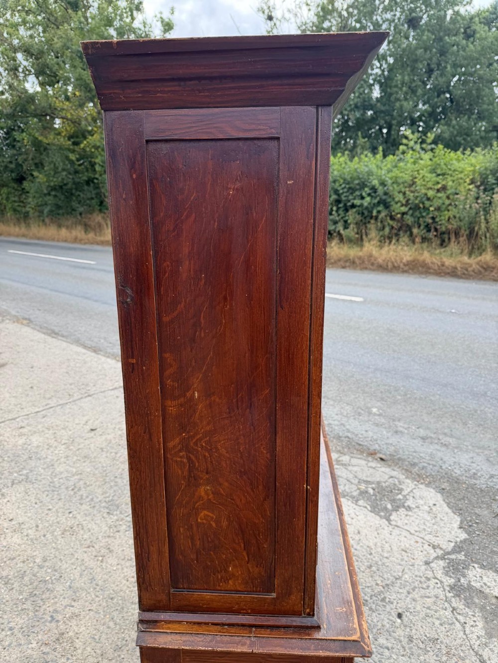 A dark stained Victorian pine dresser featuring a three-door glazed upper display cabinet over a base with three central drawers and two panelled cupboard doors. View XV