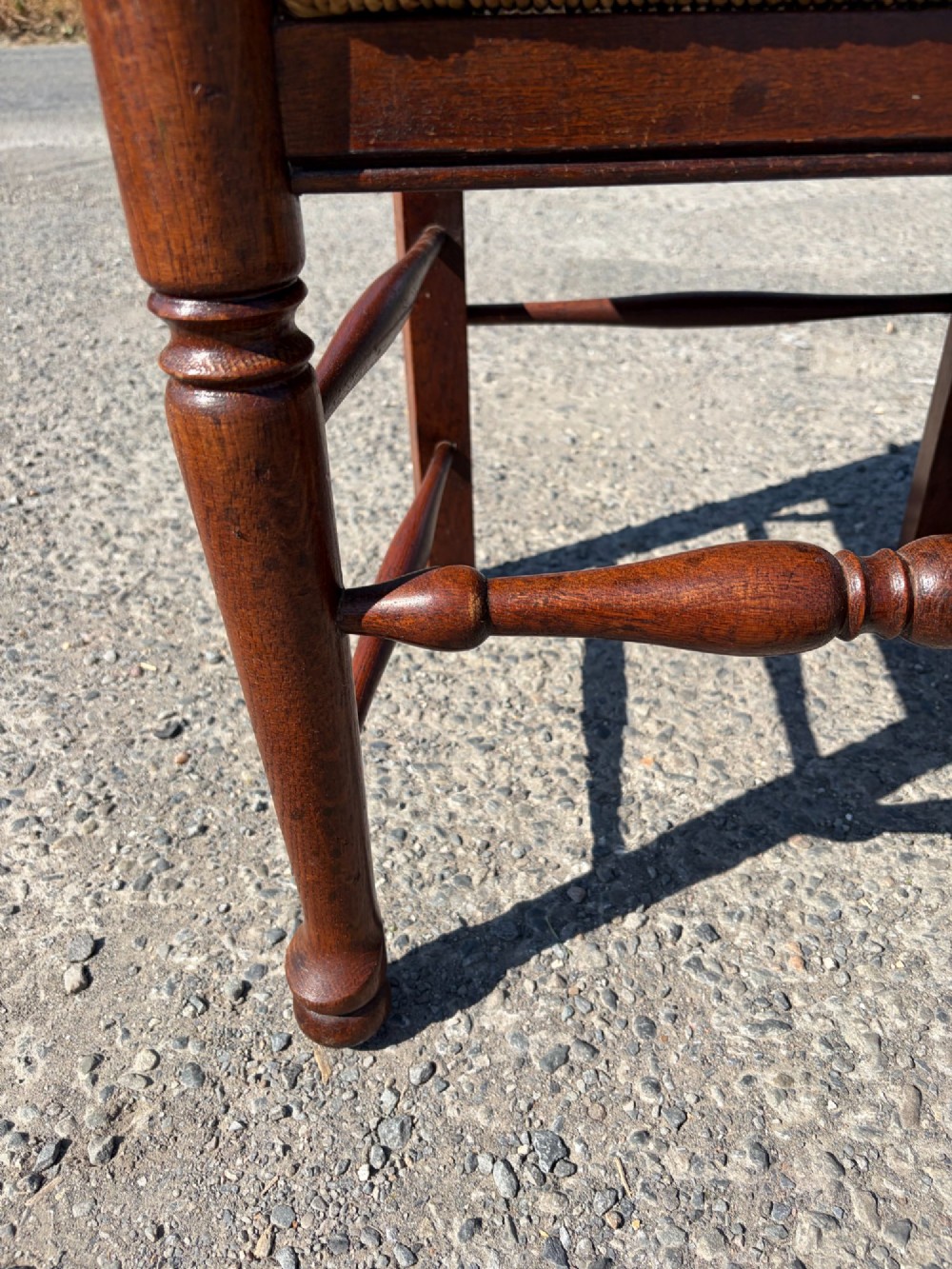 A pair of 19th-century Lancashire ladderback oak carver armchairs featuring curved back slats, turned stretchers, and hand-woven rush seats. View IX