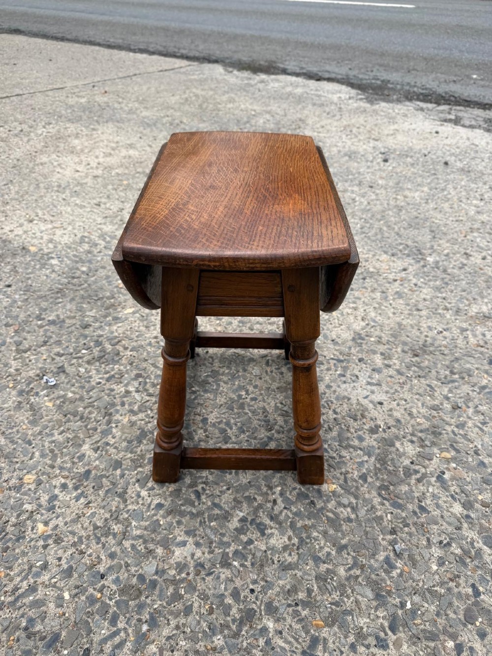 A small 1920s oak drop-leaf coffee table with turned legs and a warm brown finish. View II