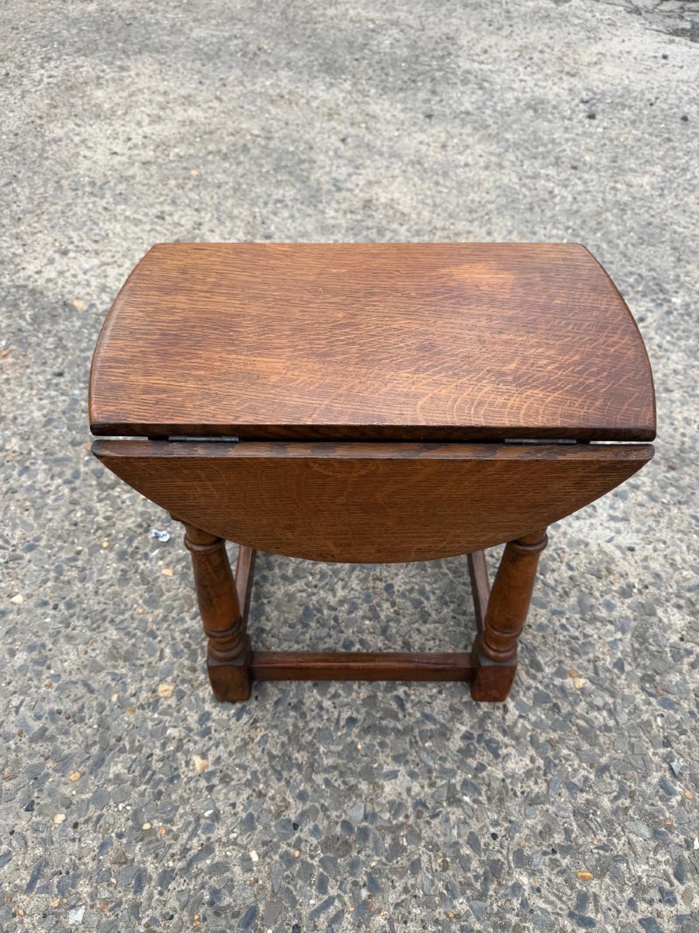 A small 1920s oak drop-leaf coffee table with turned legs and a warm brown finish. View III