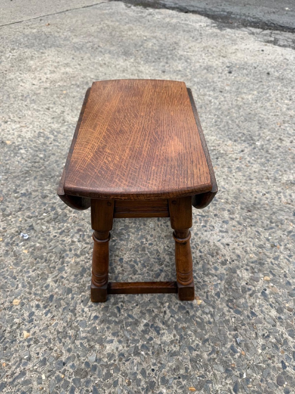 A small 1920s oak drop-leaf coffee table with turned legs and a warm brown finish. View VI