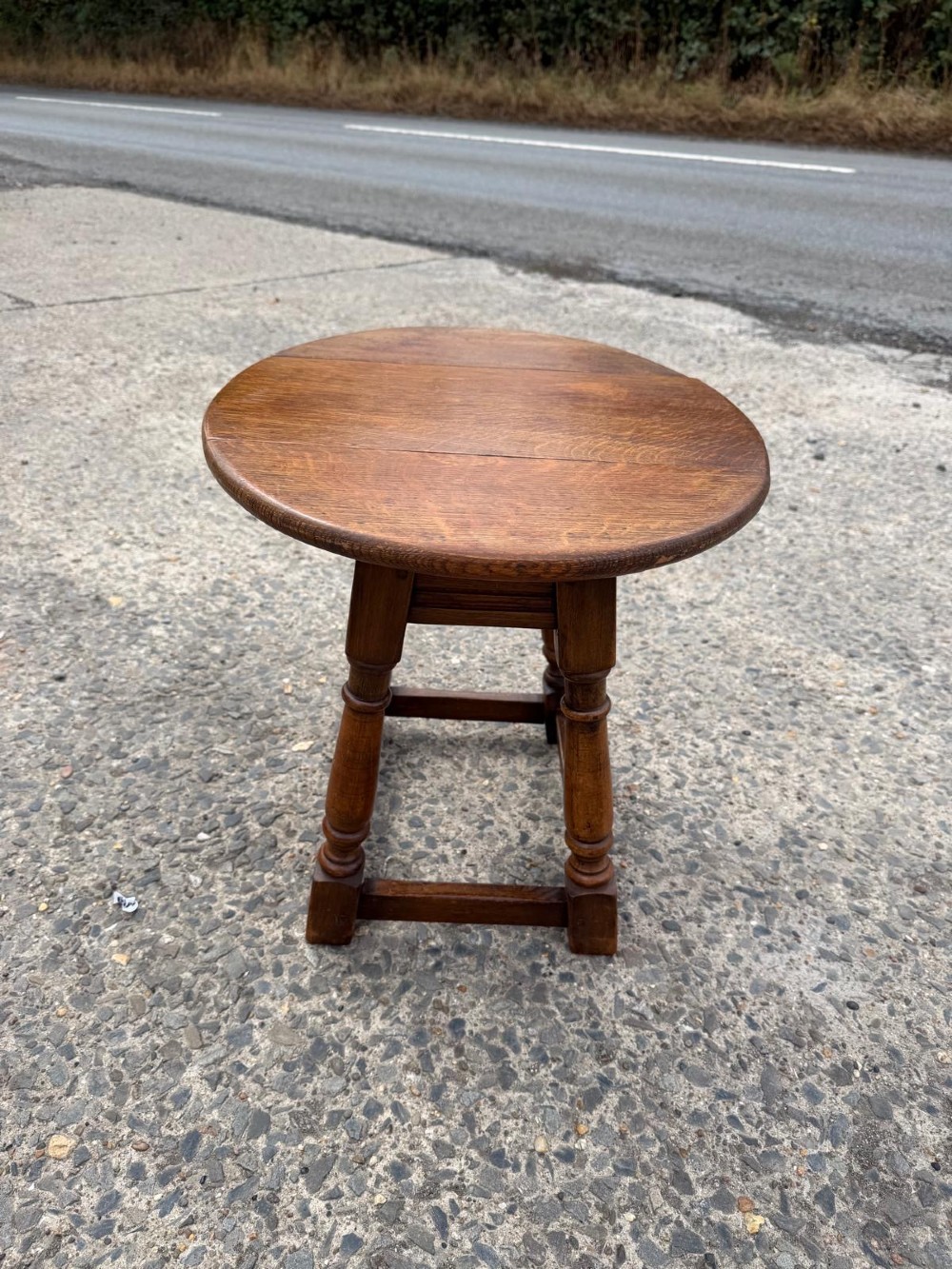 A small 1920s oak drop-leaf coffee table with turned legs and a warm brown finish. View VIII