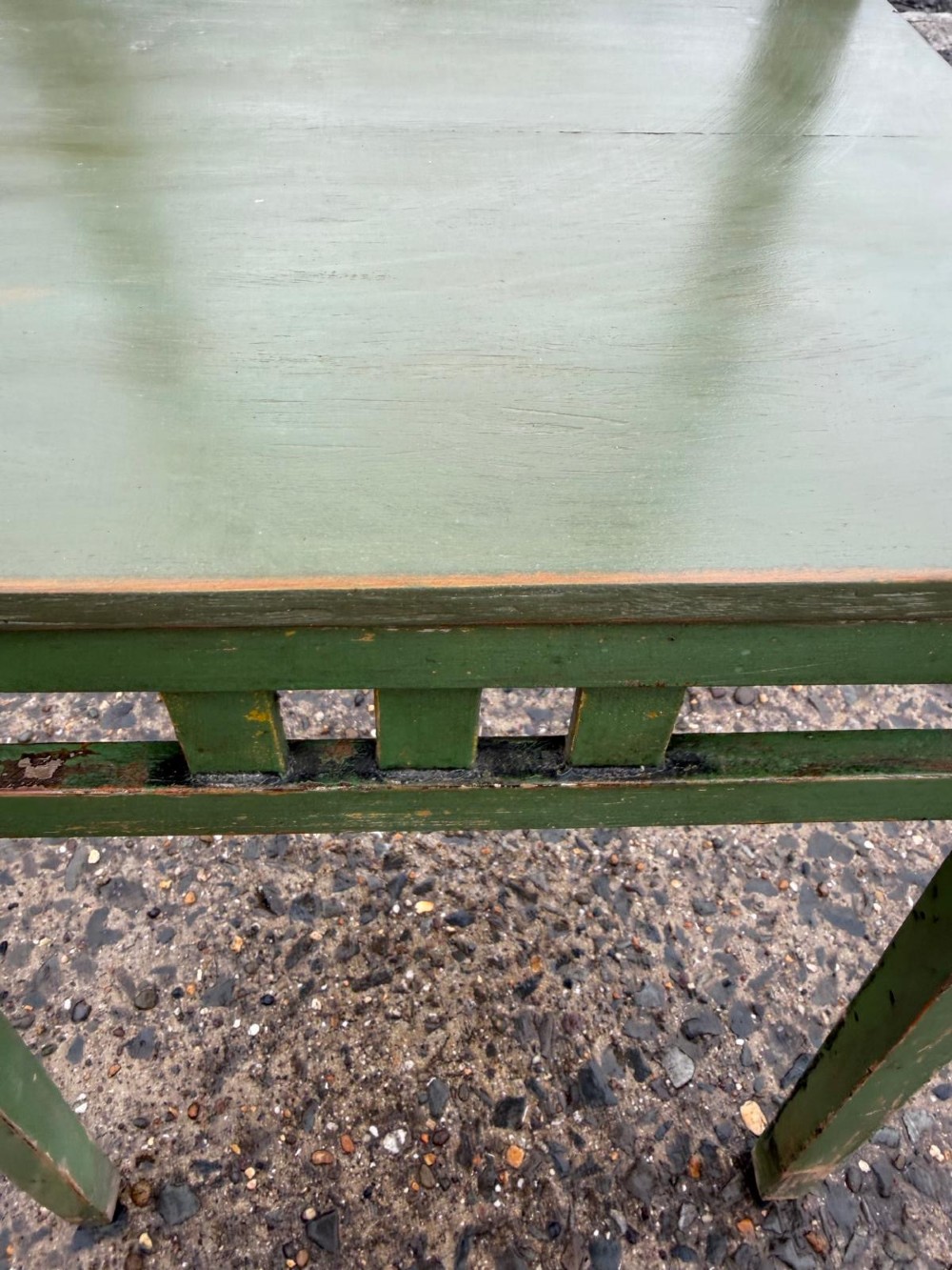 A tall, slender green painted timber plant stand circa 1900, featuring four tiered platforms and arched support brackets. View II