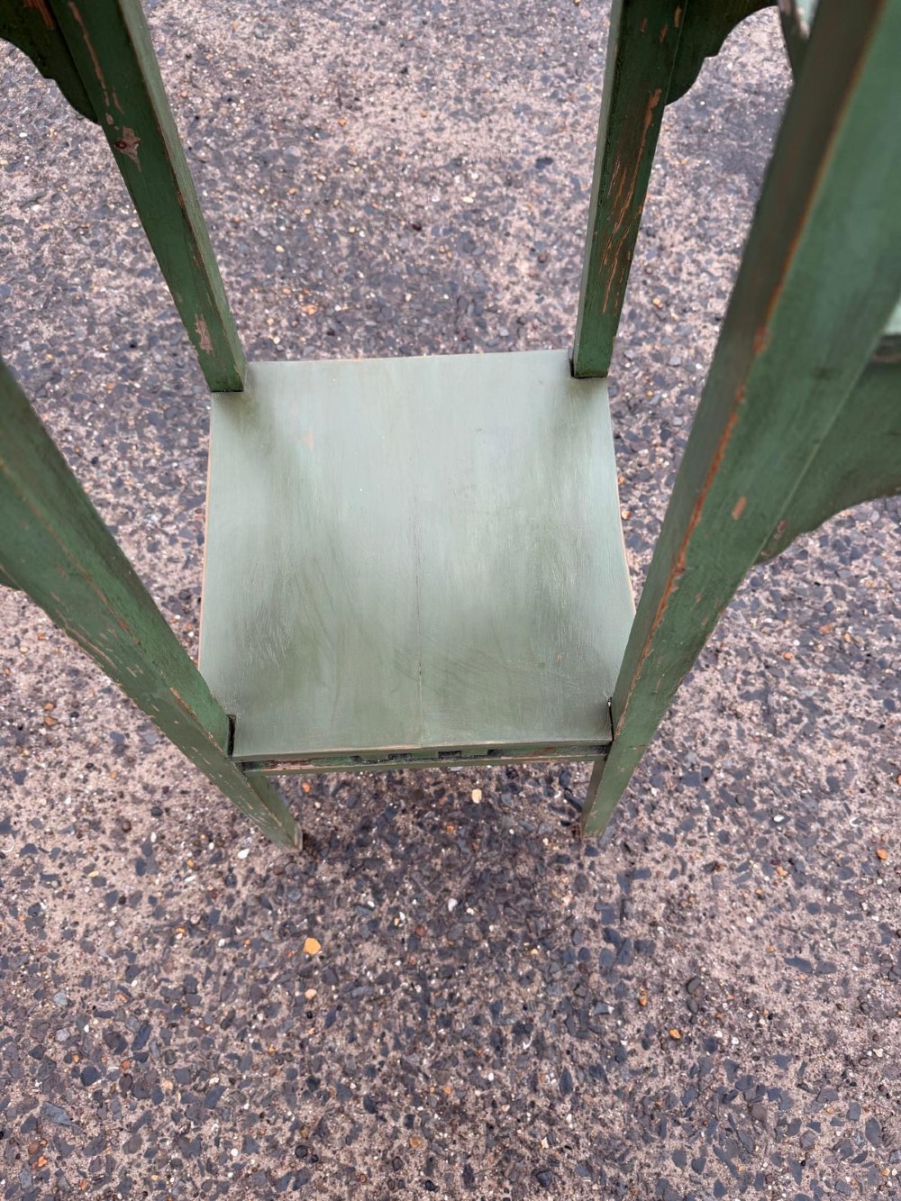 A tall, slender green painted timber plant stand circa 1900, featuring four tiered platforms and arched support brackets. View III