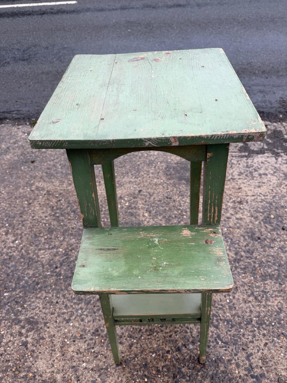 A tall, slender green painted timber plant stand circa 1900, featuring four tiered platforms and arched support brackets. View V