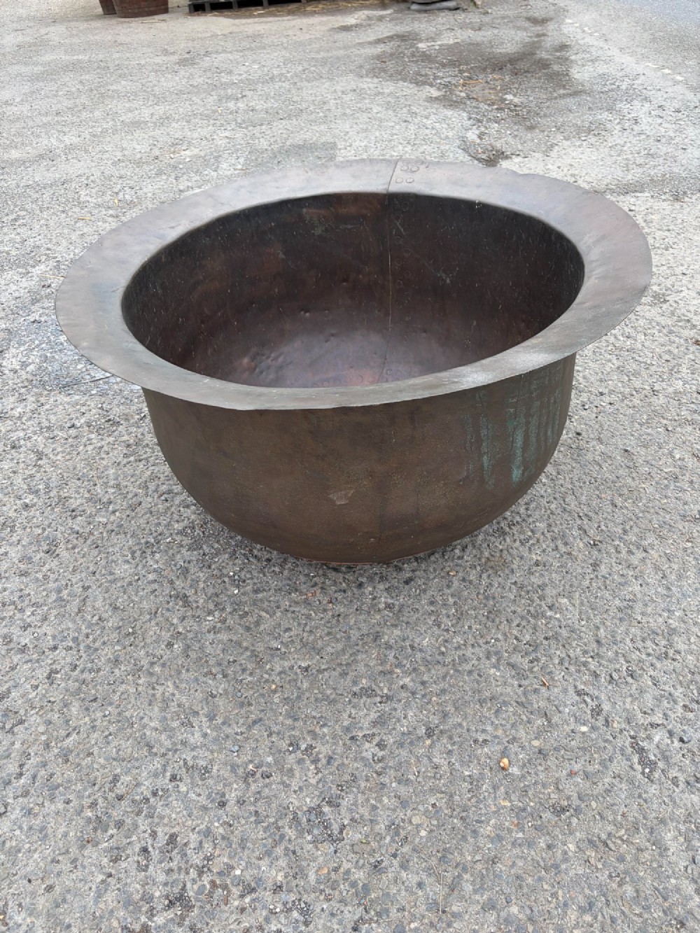 A large 19th-century copper pot featuring a wide flared rim, deep rounded vessel, and dark oxidized copper patina with subtle verdigris details. View III