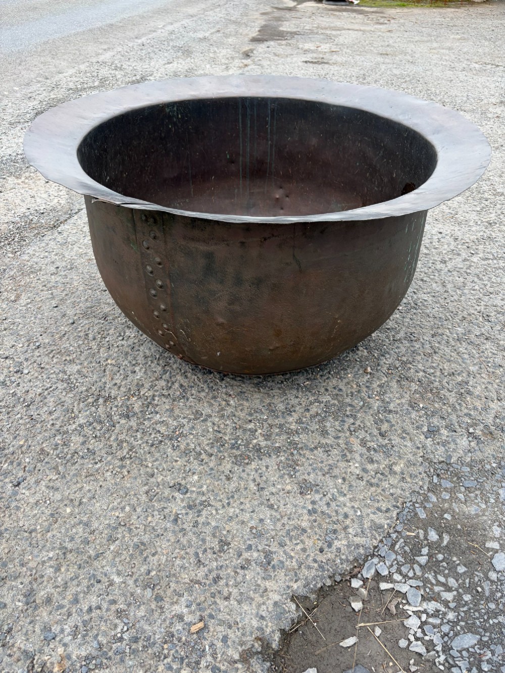 A large 19th-century copper pot featuring a wide flared rim, deep rounded vessel, and dark oxidized copper patina with subtle verdigris details. View IV