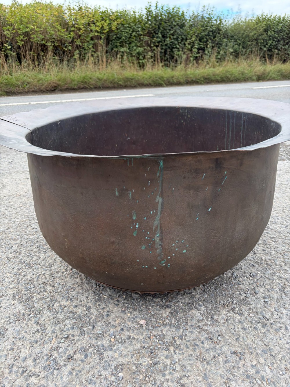 A large 19th-century copper pot featuring a wide flared rim, deep rounded vessel, and dark oxidized copper patina with subtle verdigris details. View VI