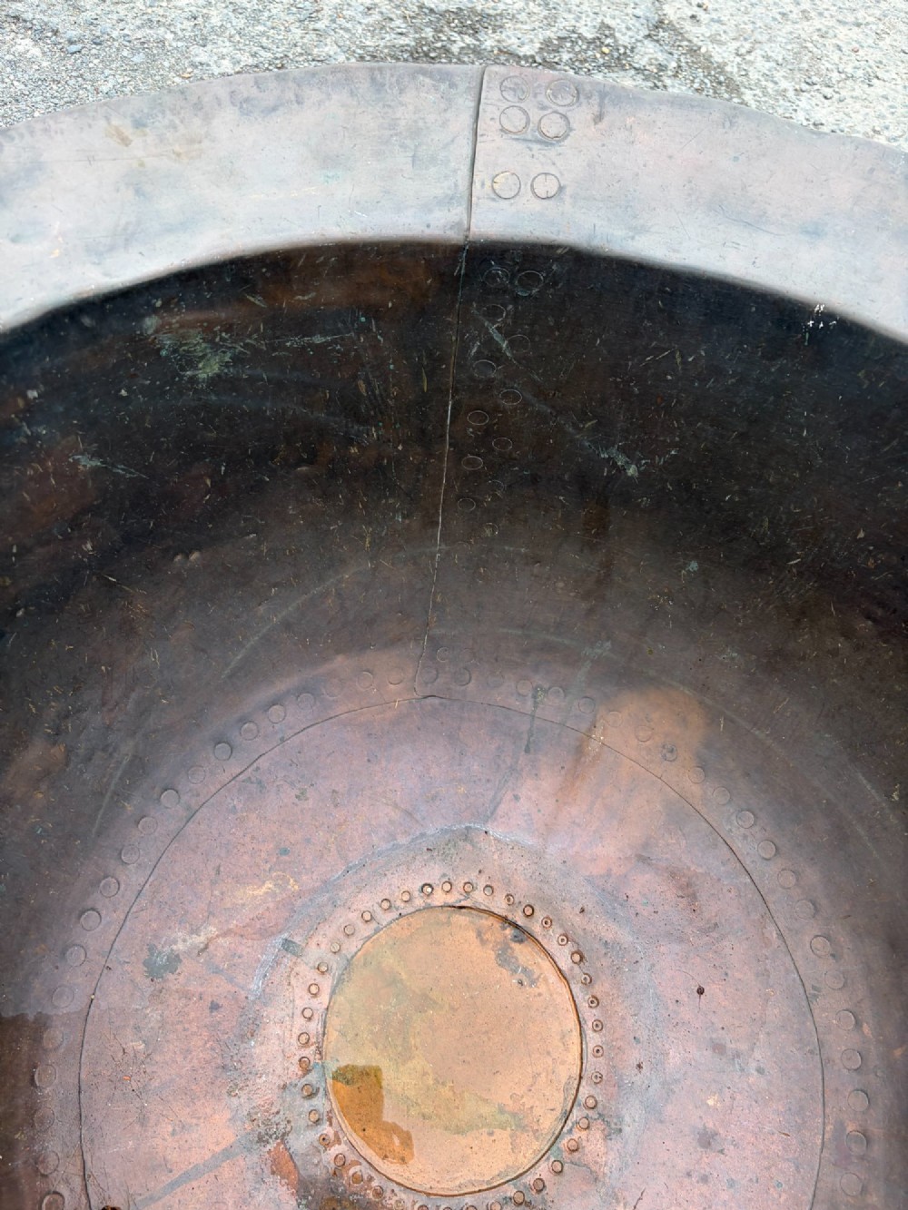 A large 19th-century copper pot featuring a wide flared rim, deep rounded vessel, and dark oxidized copper patina with subtle verdigris details. View VIII