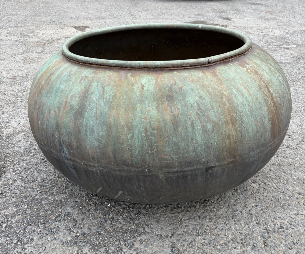 A large bulbous 19th-century copper pot featuring a rolled rim and a heavily weathered verdigris patina. View V