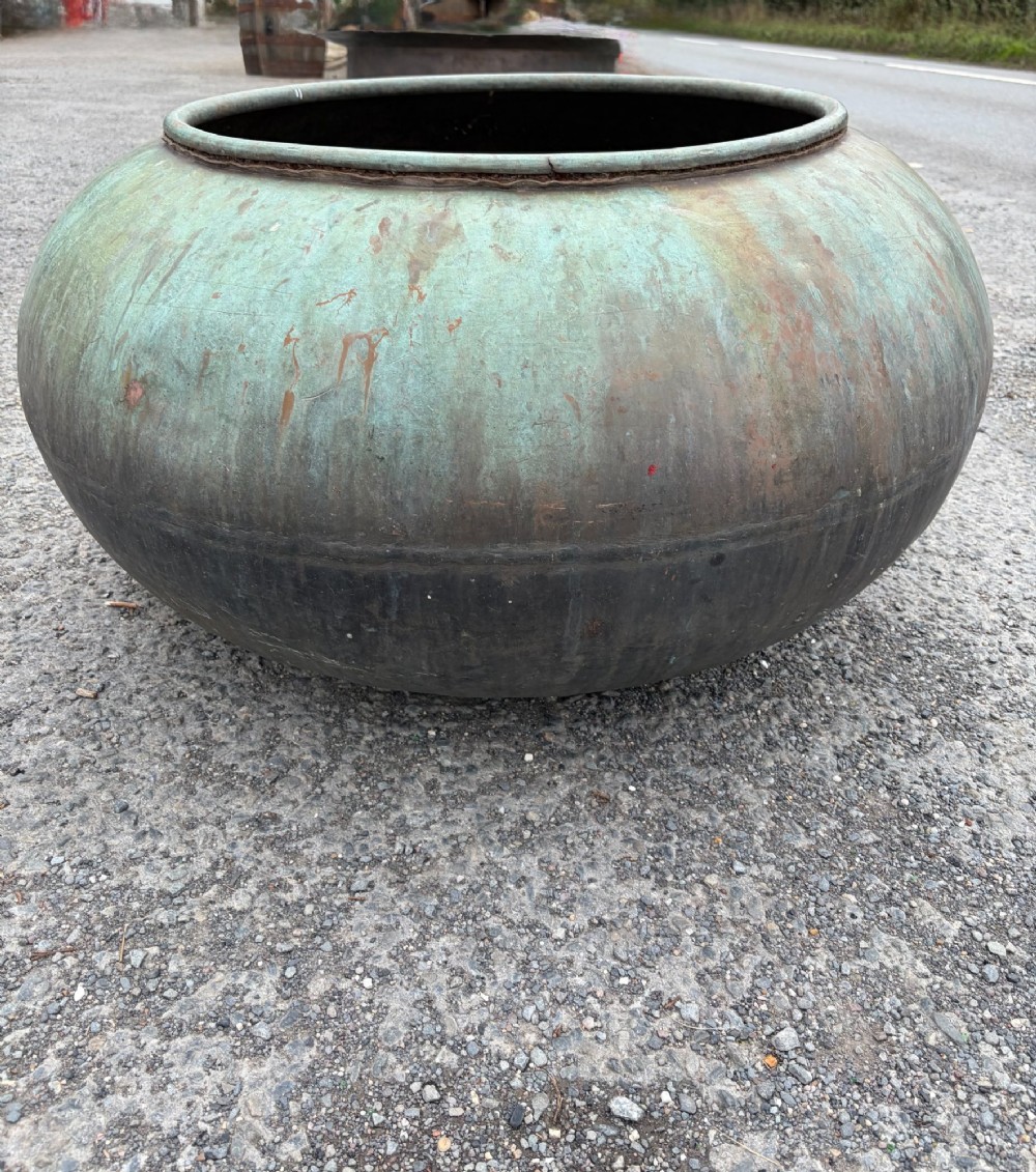 A large bulbous 19th-century copper pot featuring a rolled rim and a heavily weathered verdigris patina. View VI