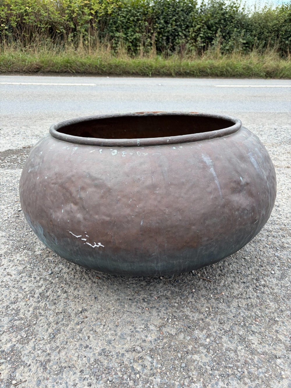 A large 19th-century rounded copper pot with a hand-hammered surface, rolled rim, and dark patinated finish. View IV