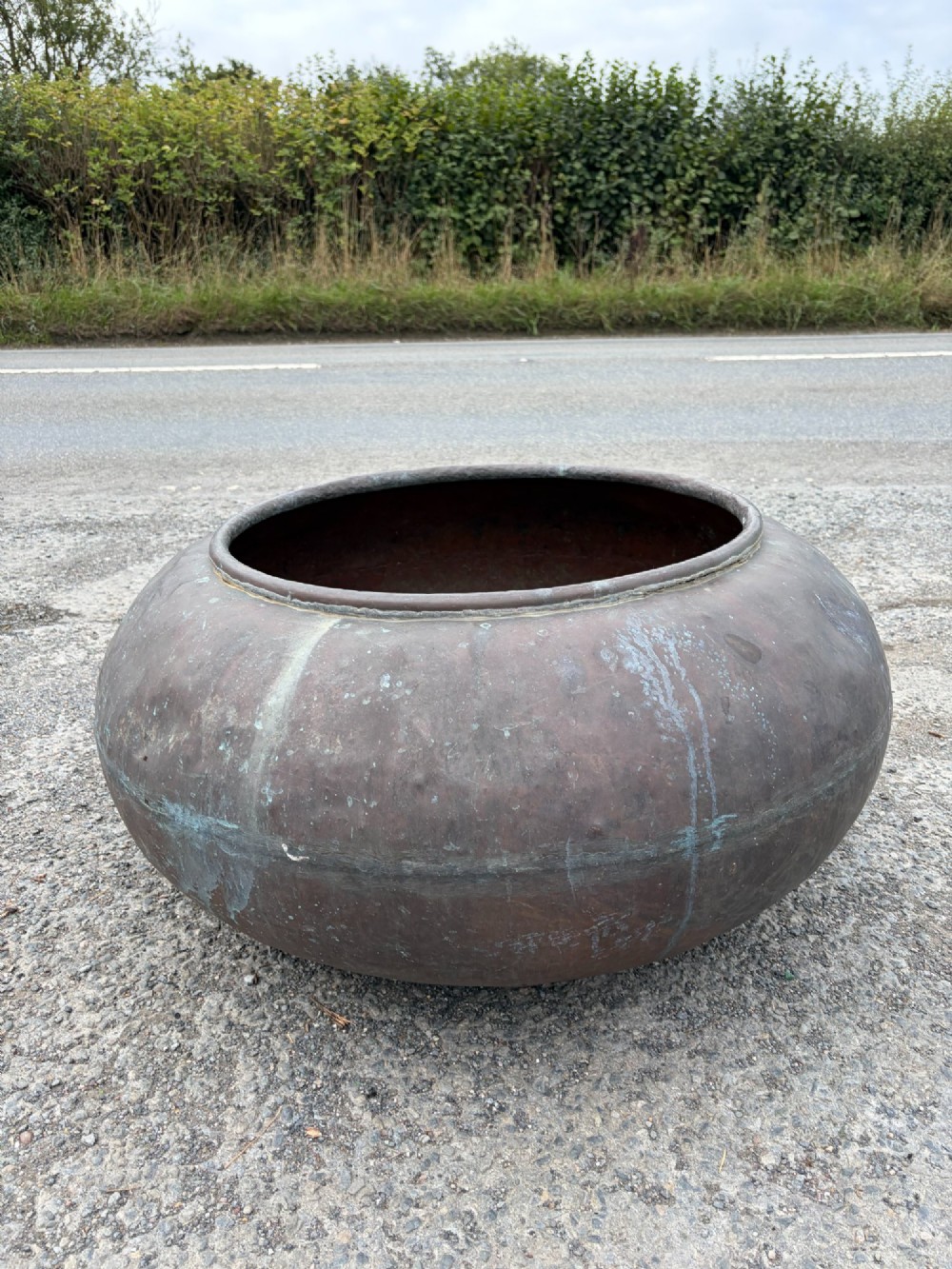 A large bulbous 19th century copper pot featuring a rolled rim, a horizontal seam line, and natural verdigris oxidisation across its surface. View III
