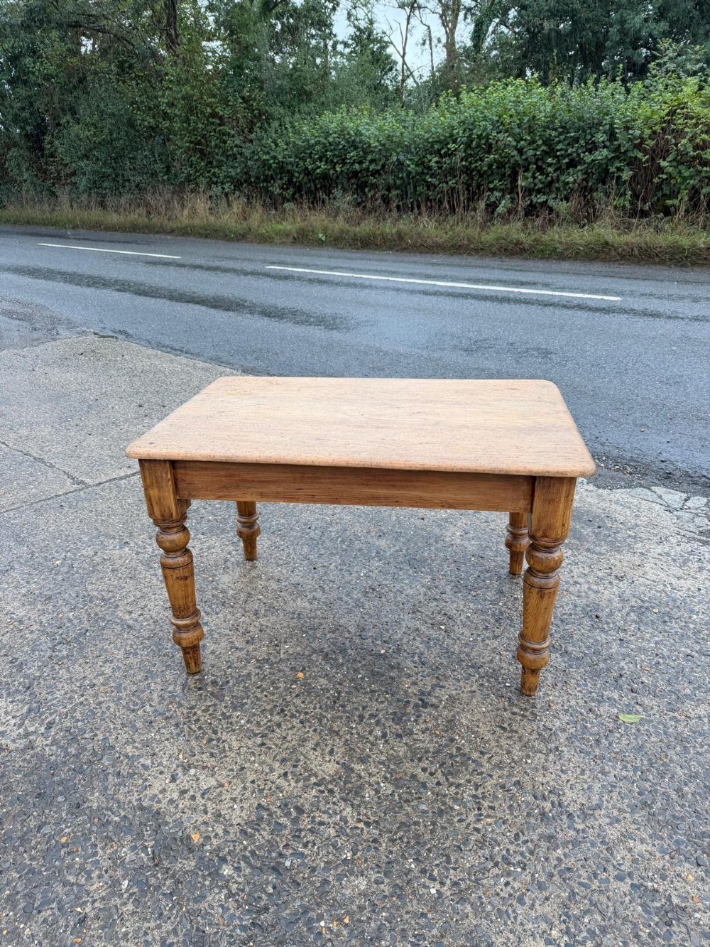 A Victorian pine table with a rectangular top, single frieze drawer, and four turned legs. View II
