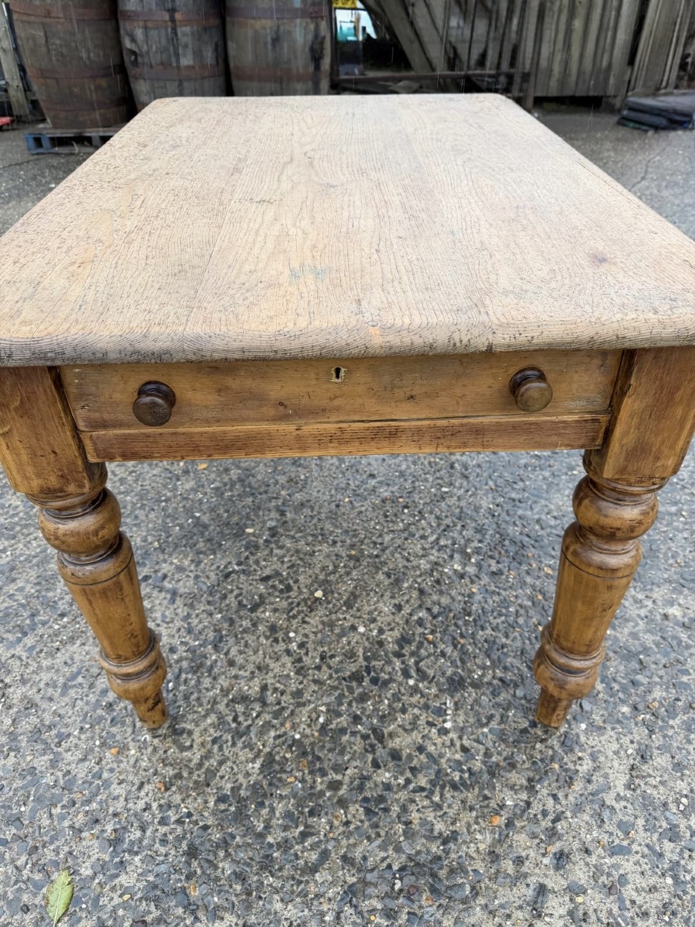 A Victorian pine table with a rectangular top, single frieze drawer, and four turned legs. View III