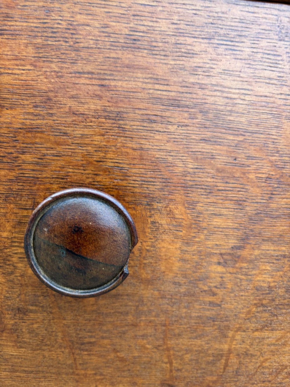 A Victorian warm brown oak chest of drawers featuring two short drawers above four full-width long drawers with turned wooden handles and keyholes. View IX