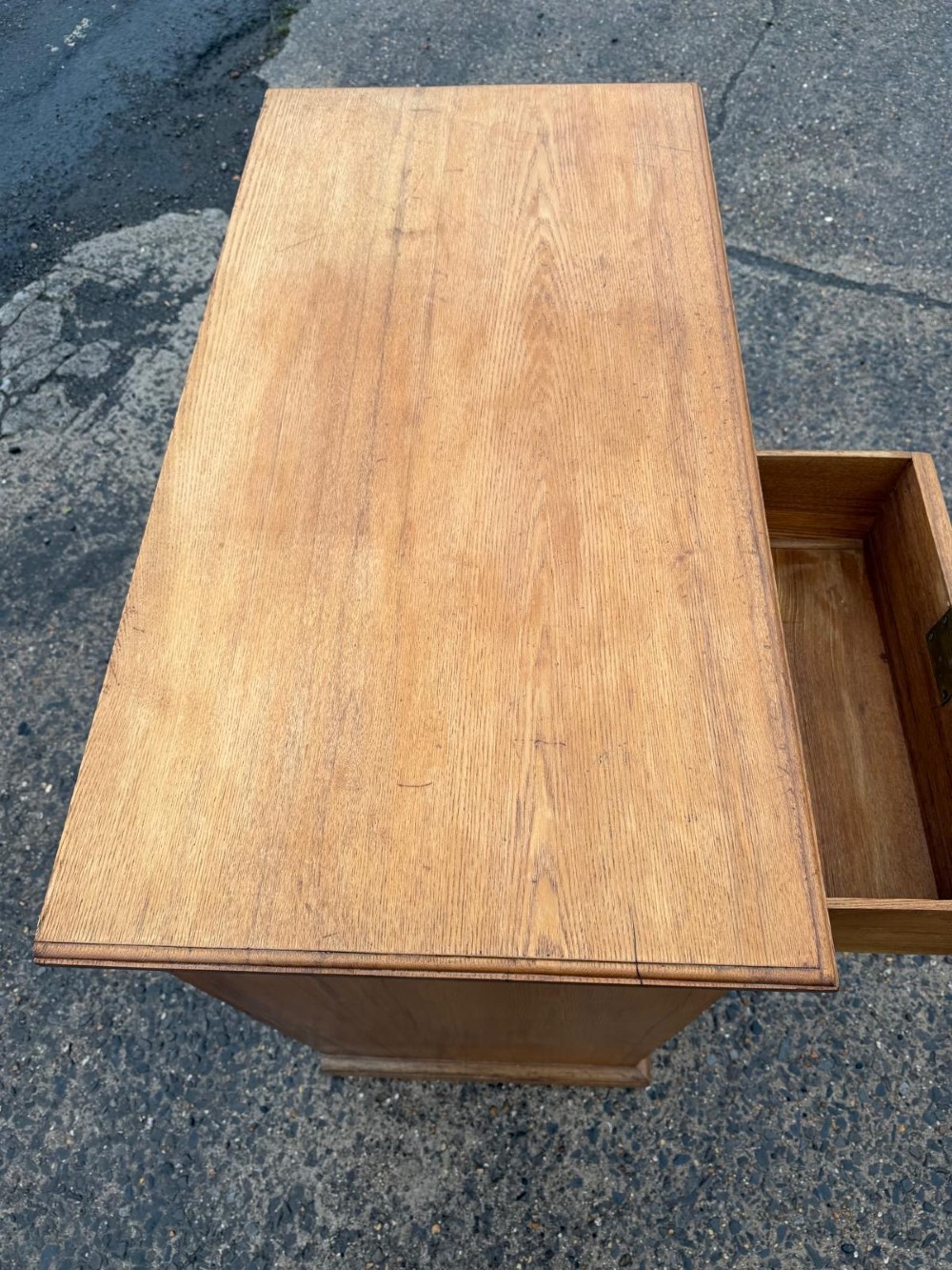 A solid oak chest of drawers featuring a two over three drawer layout with fluted side pilasters and brass acorn drop handles set on a solid base. View VII