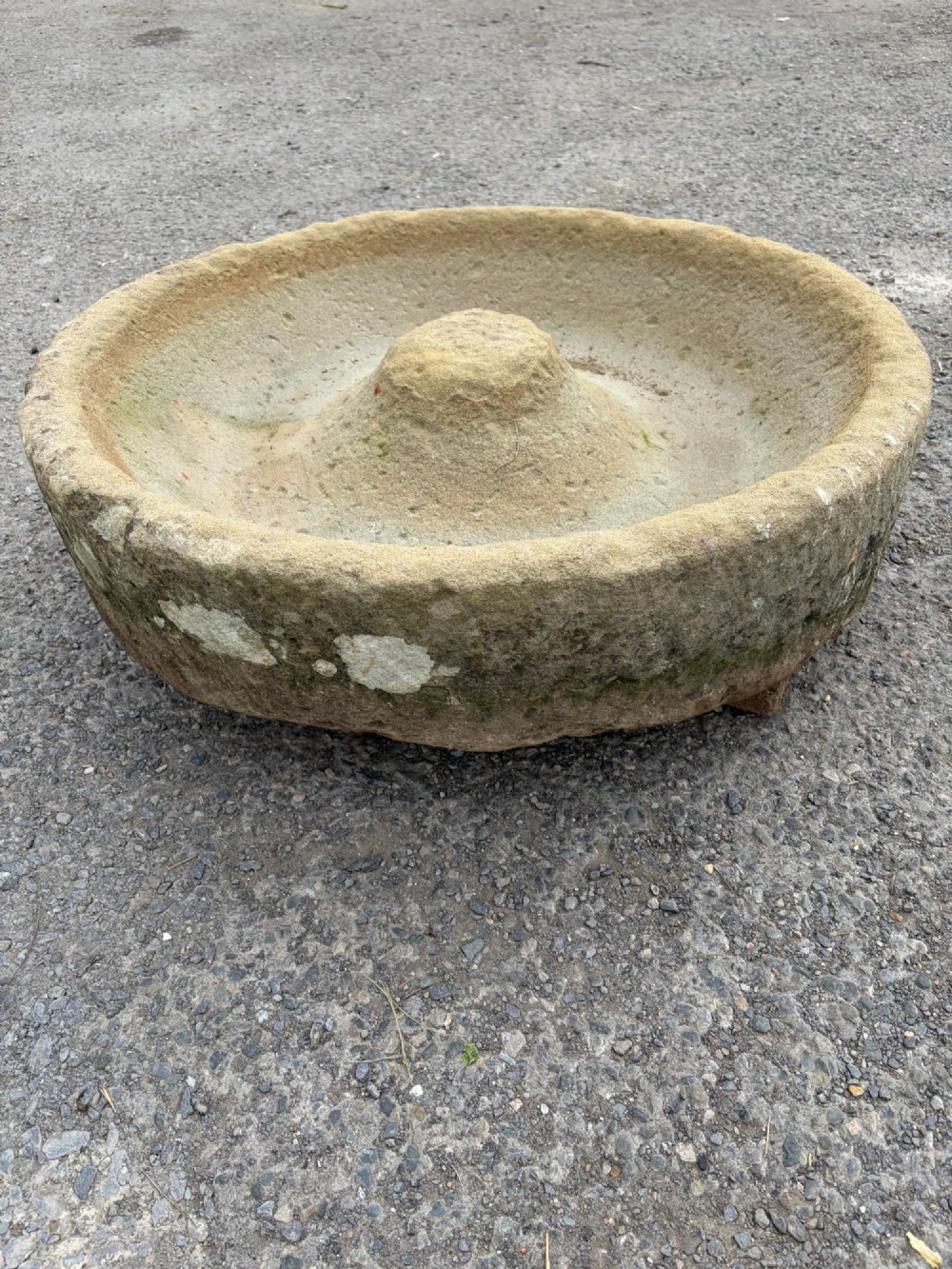 A circular hand-carved antique sandstone pig trough featuring a raised central cone and weathered exterior surface. View VII