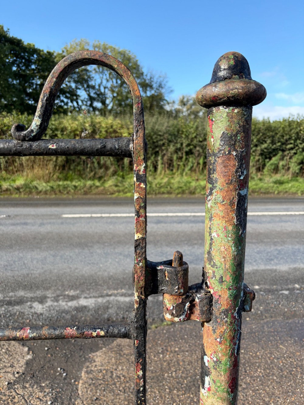 An early 19th-century wrought iron pedestrian field gate with supporting posts, horizontal bars, diagonal bracing, and a weathered paint finish. View IX