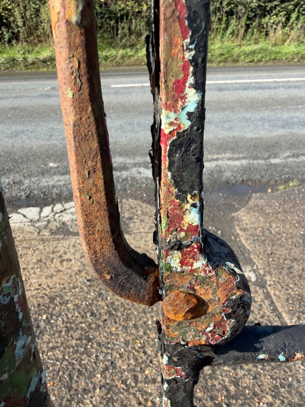 An early 19th-century wrought iron pedestrian field gate with supporting posts, horizontal bars, diagonal bracing, and a weathered paint finish. View XI