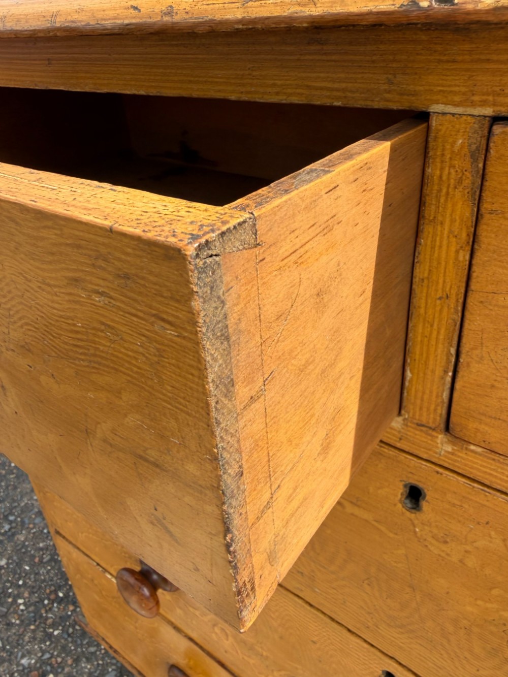 A Victorian pine chest of drawers featuring a faux-grained finish, two short drawers over three long drawers, turned wooden knobs, and turned feet. View IV