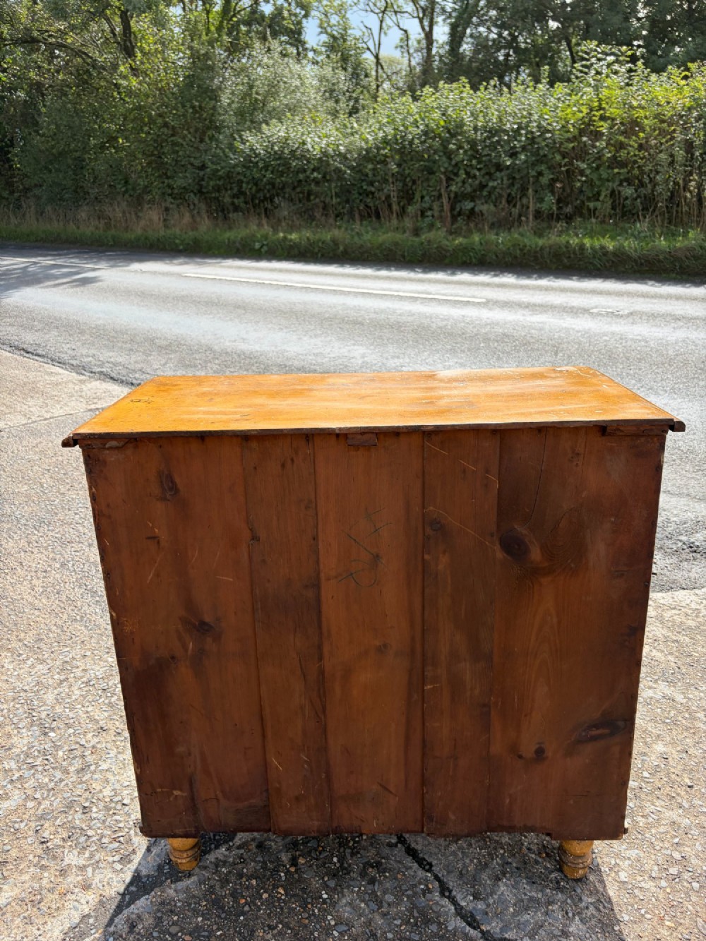A Victorian pine chest of drawers featuring a faux-grained finish, two short drawers over three long drawers, turned wooden knobs, and turned feet. View VII