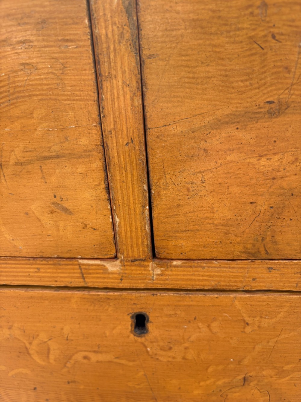 A Victorian pine chest of drawers featuring a faux-grained finish, two short drawers over three long drawers, turned wooden knobs, and turned feet. View IX