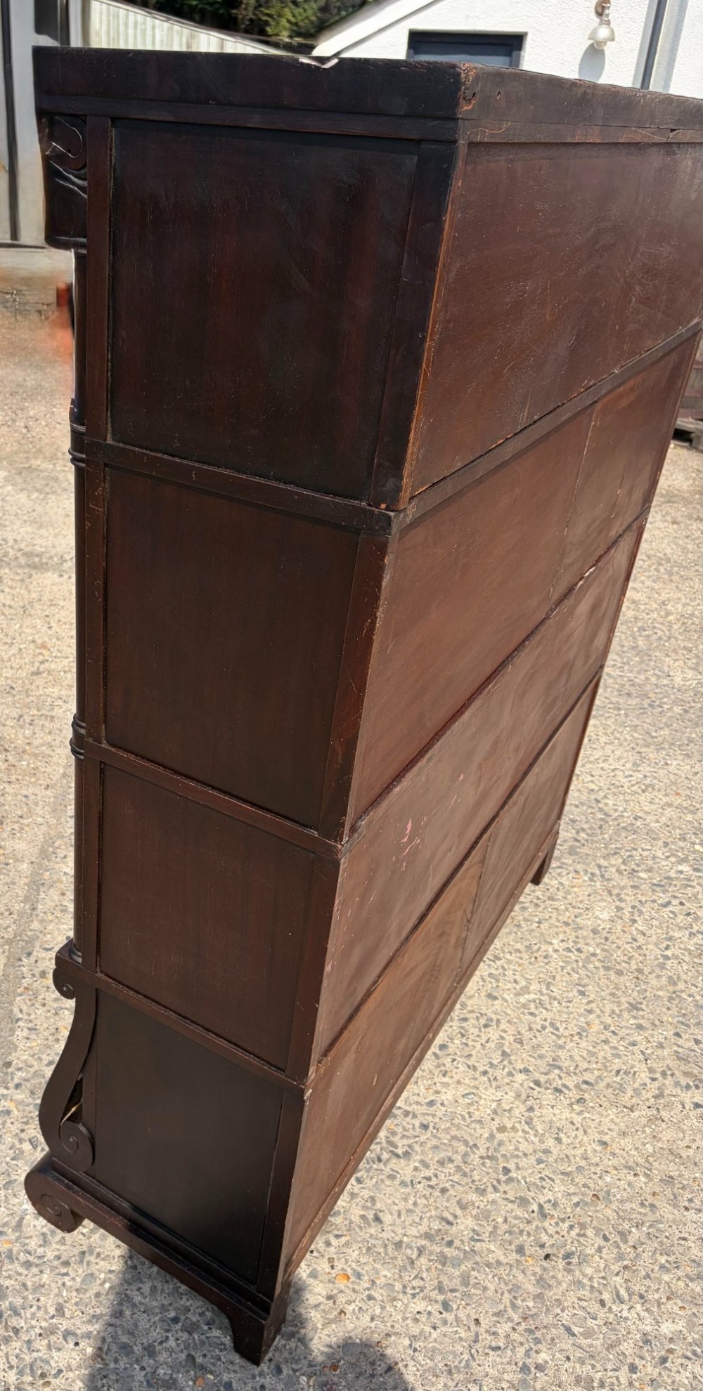 A 1920s dark mahogany double-width sectional bookcase featuring four stacked tiers fitted with glazed up-and-over doors. View VI