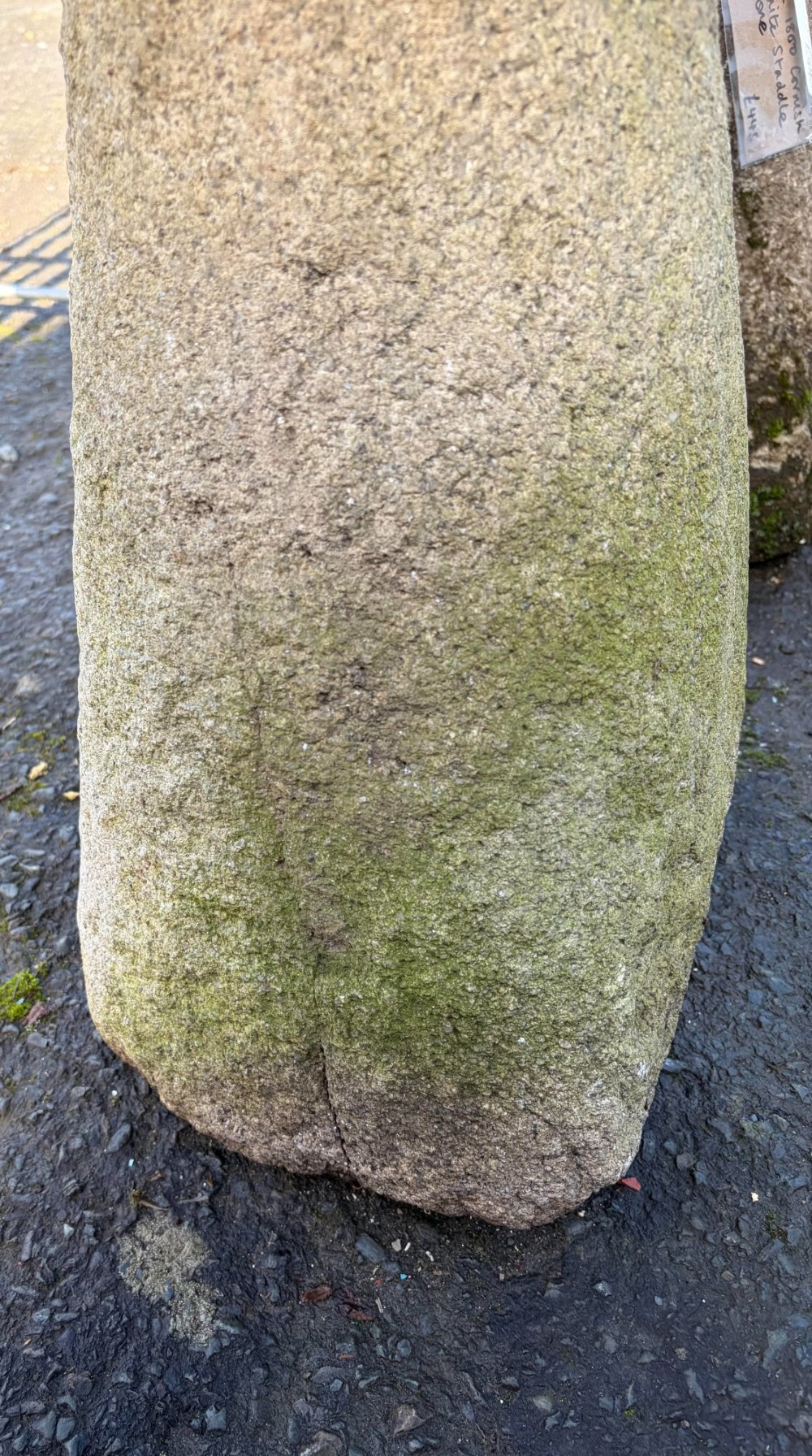 A hand-hewn grey Cornish granite staddle stone with a tapered base and rounded cap resting on a flat surface. View VII