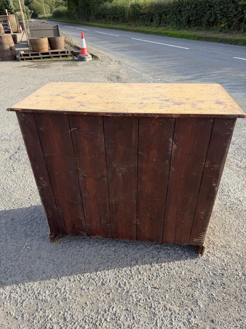 A Victorian painted pine chest of drawers in a two over three drawer layout with brass drop handles and distressed original yellow paint. View VIII