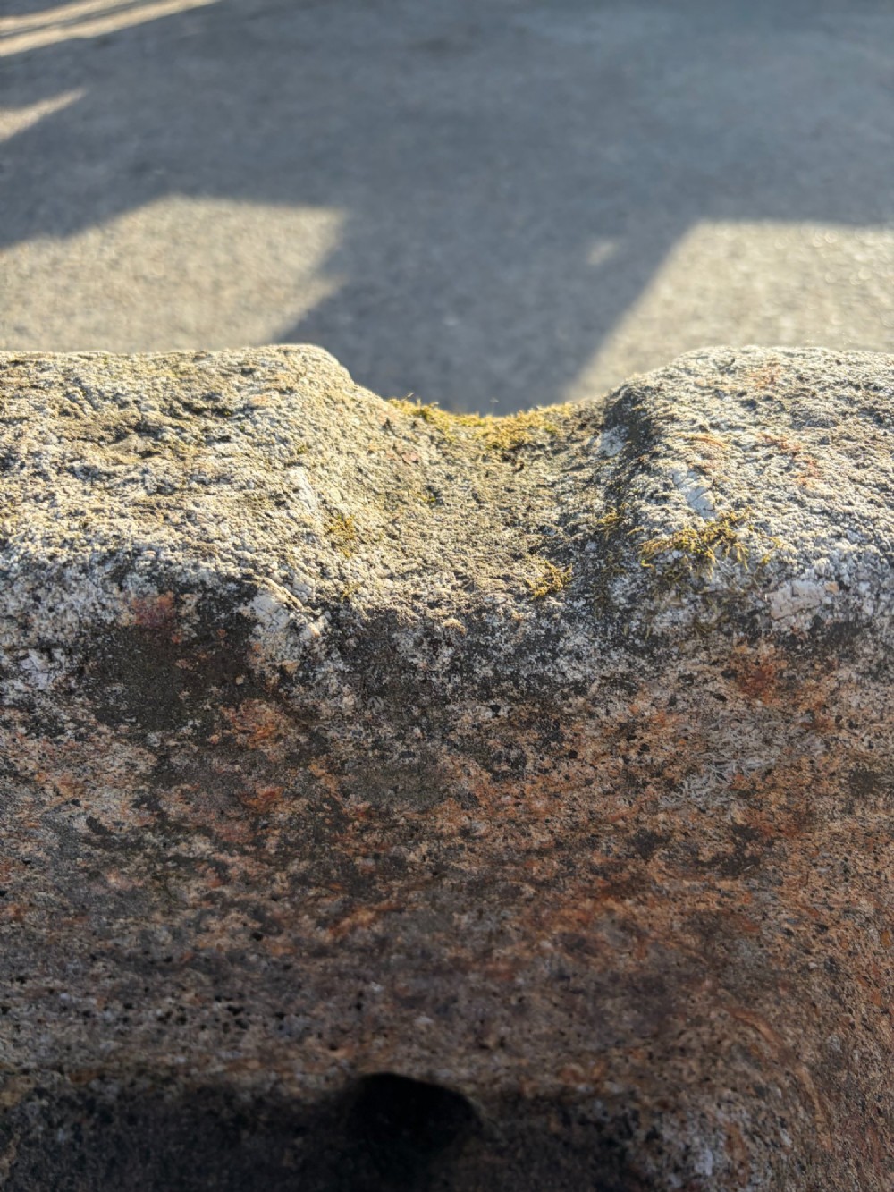 A heavy rectangular antique Cornish granite trough featuring a hand-chiselled rough stone exterior and carved basin. View III