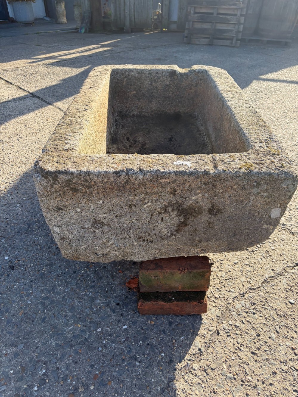 A heavy rectangular antique Cornish granite trough featuring a hand-chiselled rough stone exterior and carved basin. View VII