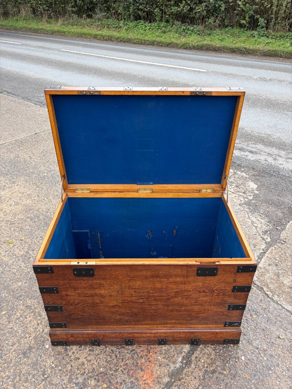 A rectangular Victorian oak silver chest with dark iron corner brackets and a brass plate set into the top lid. View IV