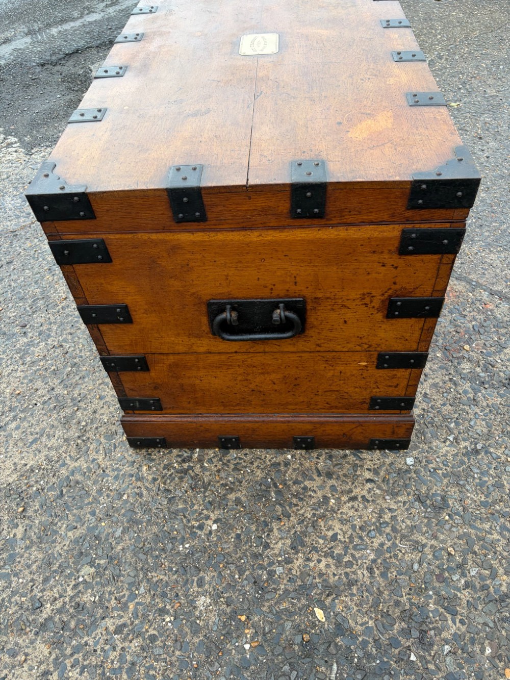 A rectangular Victorian oak silver chest with dark iron corner brackets and a brass plate set into the top lid. View VI