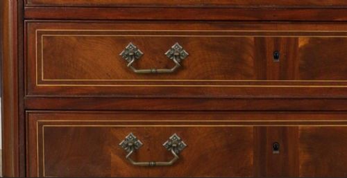 fig 1. A late eighteenth-century French walnut and fruitwood commode featuring three drawers with string inlay, brass handles, and a grey marble top.