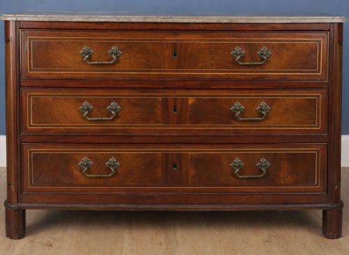 A late eighteenth-century French walnut and fruitwood commode featuring three drawers with string inlay, brass handles, and a grey marble top. View III