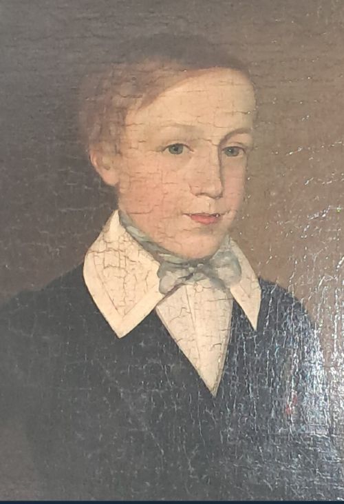 An antique oil portrait depicting a young male scholar in a dark blue coat and white collar, set in a gilded ornate frame. View VI