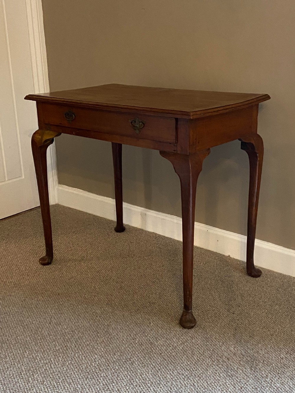 A Georgian fruitwood side table featuring cabriole legs with pad feet, a single drawer with brass handles, and a central star compass inlay on the tabletop. View VII