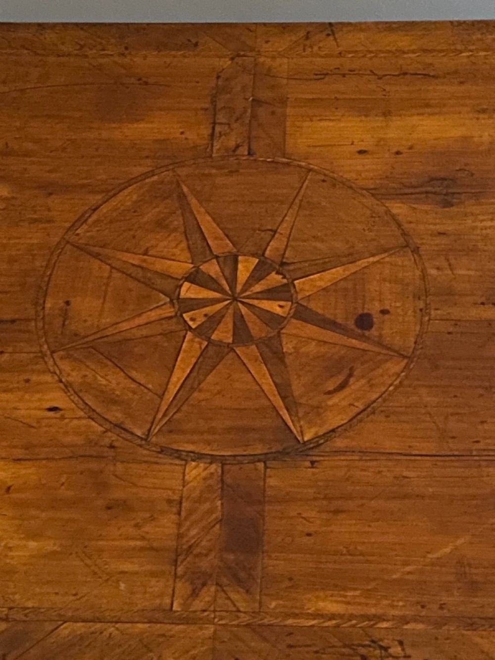 A Georgian fruitwood side table featuring cabriole legs with pad feet, a single drawer with brass handles, and a central star compass inlay on the tabletop. View III