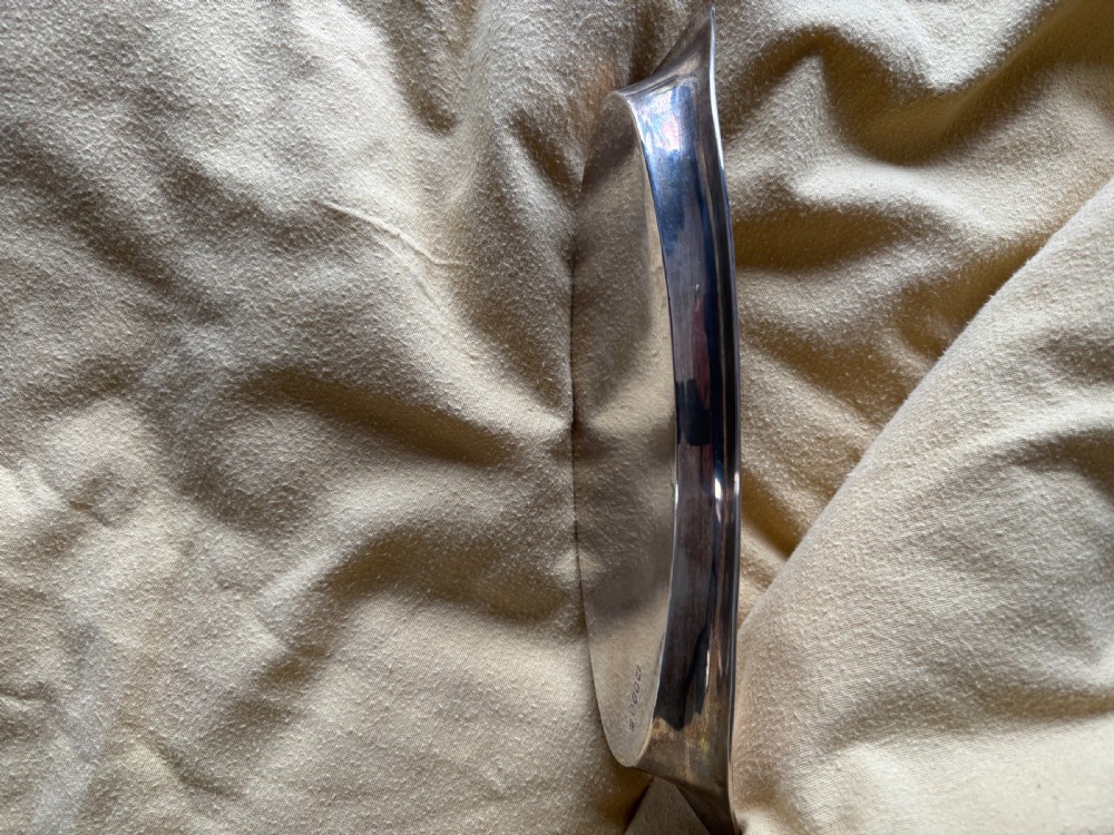 A George III sterling silver oval tray displaying visible British hallmarks stamped on its smooth inner rim. View IV