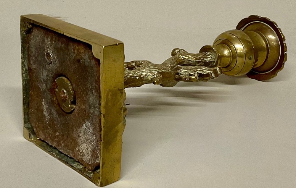 A pair of Regency gilt bronze candlesticks cast in the form of tree trunks with squirrels among the branches supporting campana sconces on square bases. View II