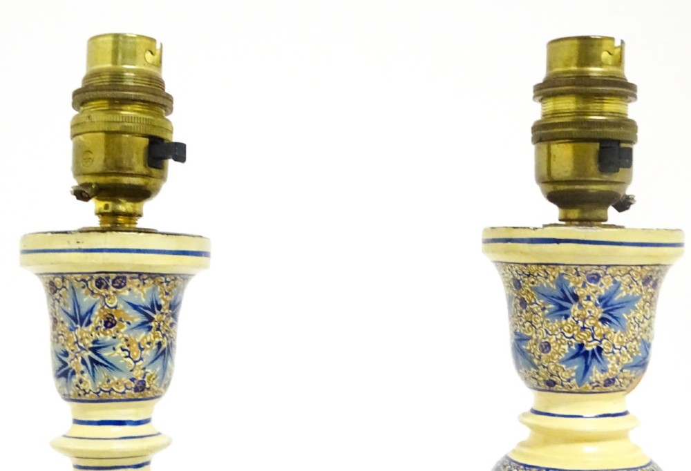 A pair of early 20th-century Kashmiri table lamps with open-spiral turned columns hand-painted in blue floral patterns on a cream lacquered ground. View II